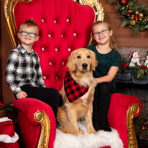 photos of kids with dog on Santa's chair